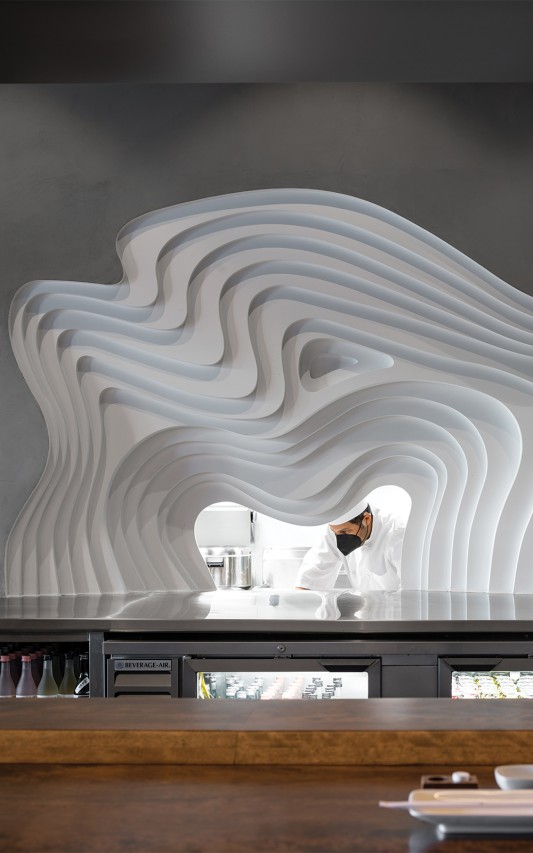 Inspired by the topography of a Rice Terraced Field, the pass-through window was digitally fabricated to create a piece of functional art that pays homage to the neighborhood.