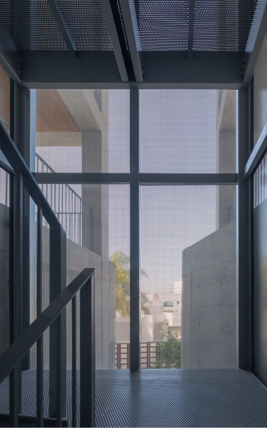 The perforated screen allows for natural ventilation and illumination while maintaining privacy in the building’s terraces.