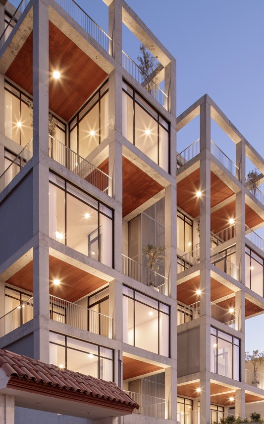 Composed in a playful arrangement, the outdoor spaces and wood ceilings, highlight the concrete frame while promoting social engagement and a sense of community among the residents.