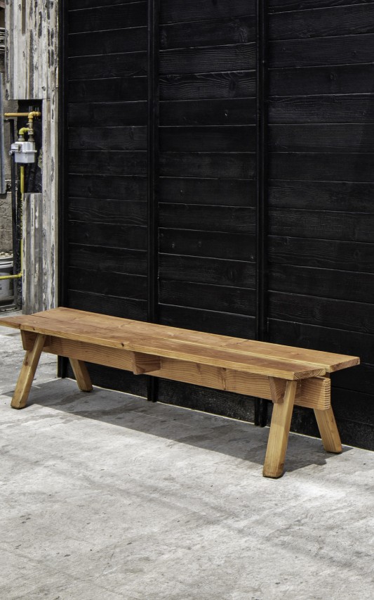 The traditional design cypress bench contrasts the Shou Sugi Ban Siding to create an elegant facade.