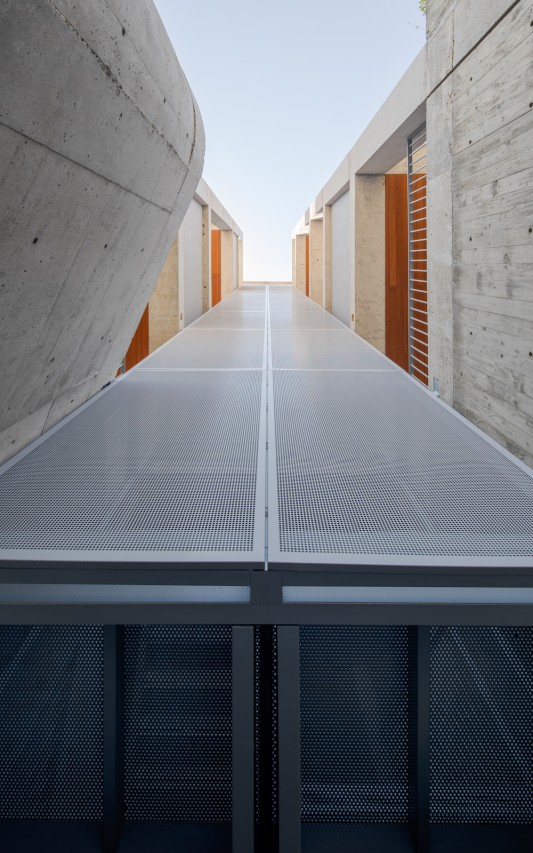 The translucent staircase at the project's center allows for the perfect amount of light penetration to naturally illuminate the space.