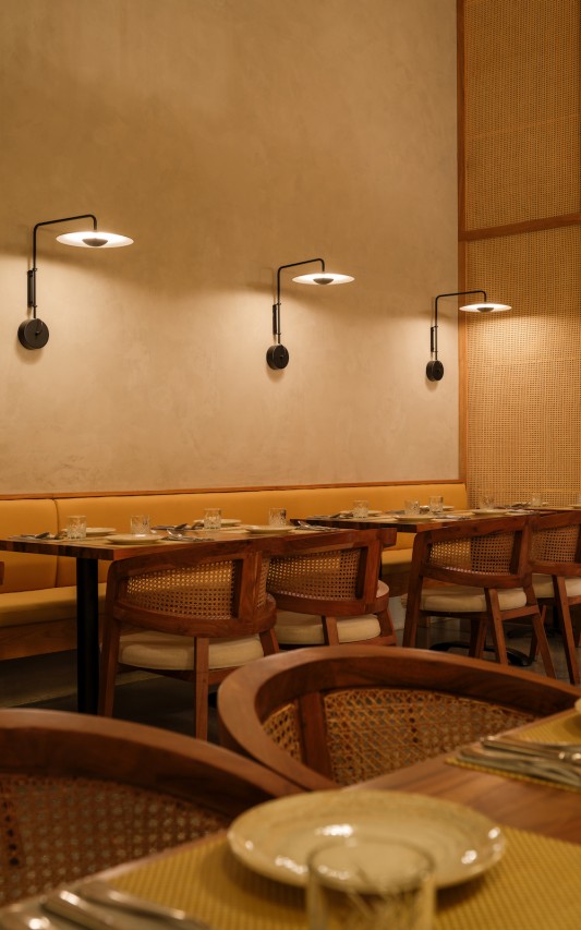 The lighting fixtures are inspired by the Western influence in India and also act as buffers for the high ceiling.