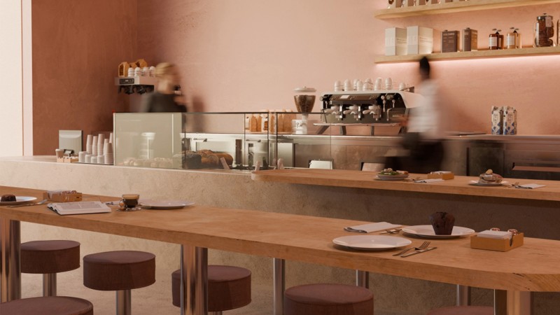 Blush-toned walls meet curved seating and softly diffused lighting, casting an ambient warmth across the space. 